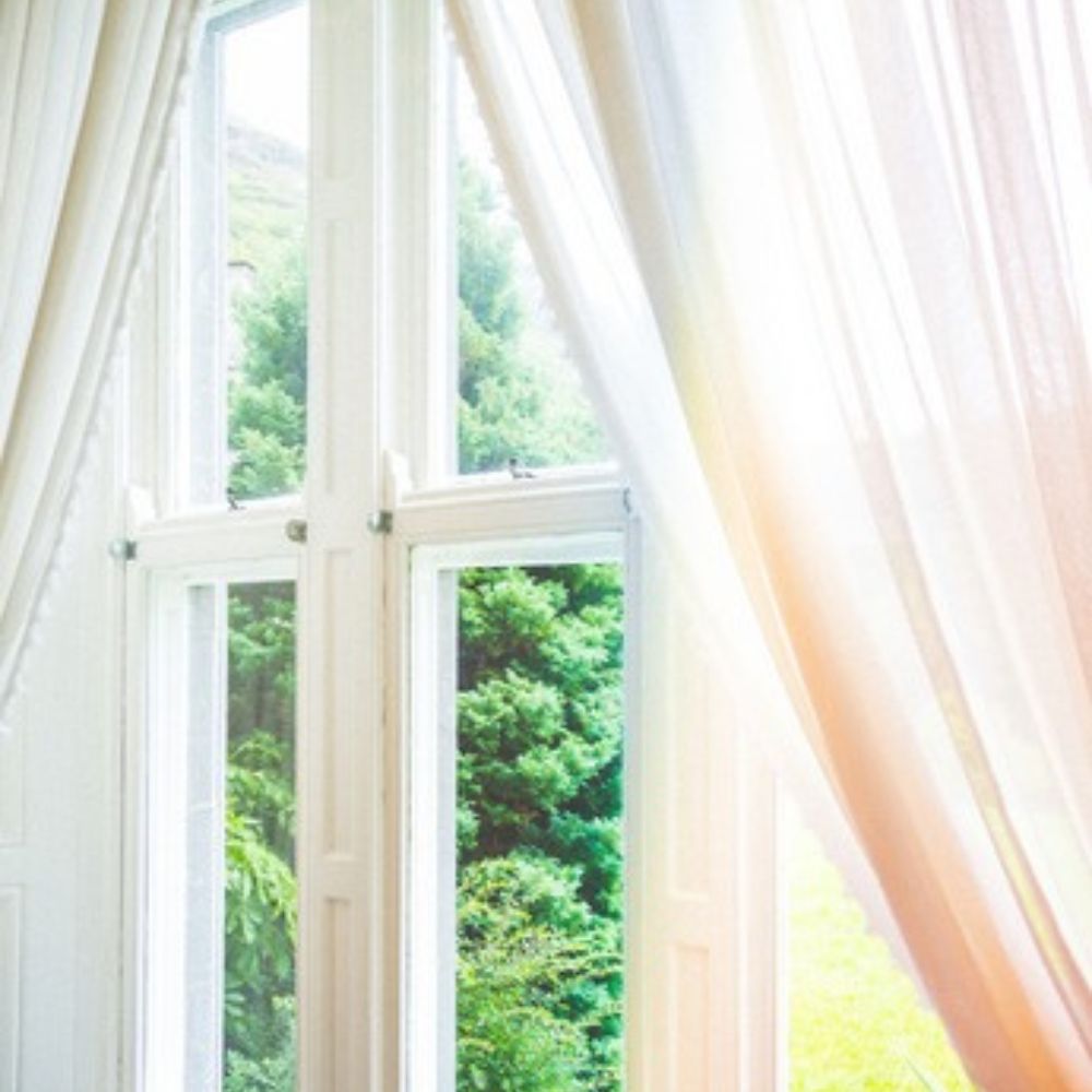 Gauzy white curtains in front of a window.